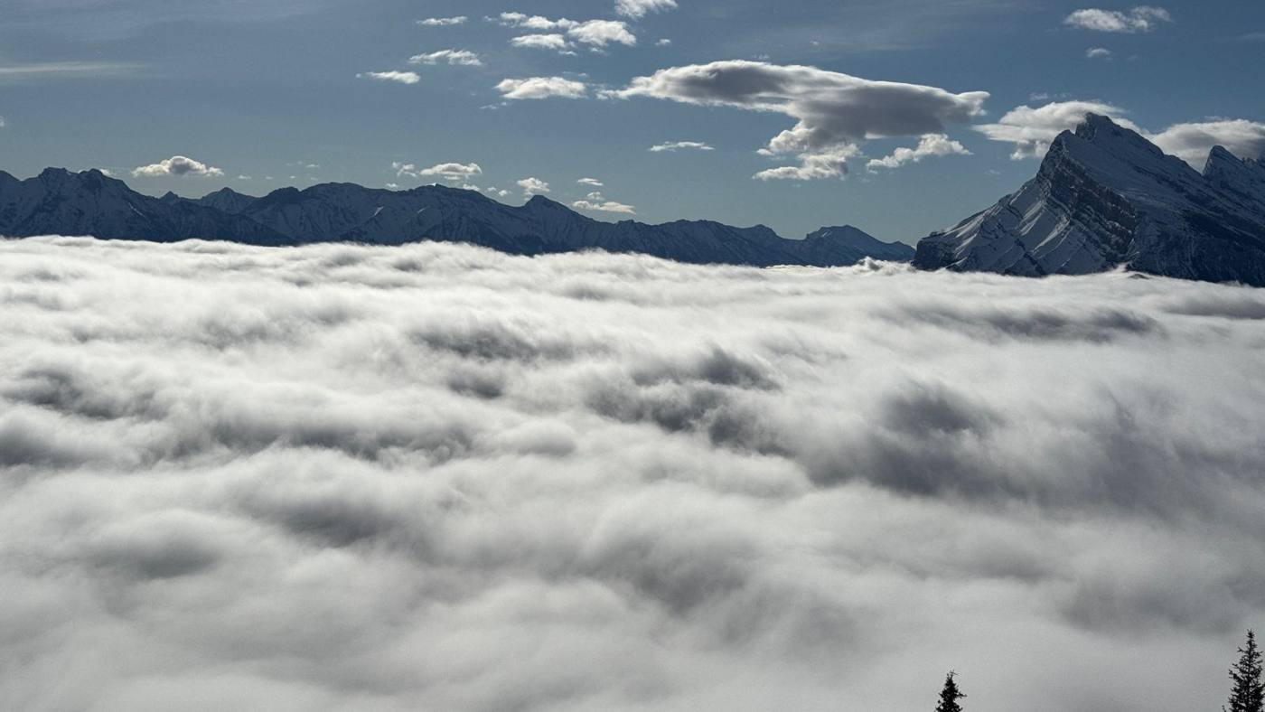 Peaks rising above a valley full of cloud