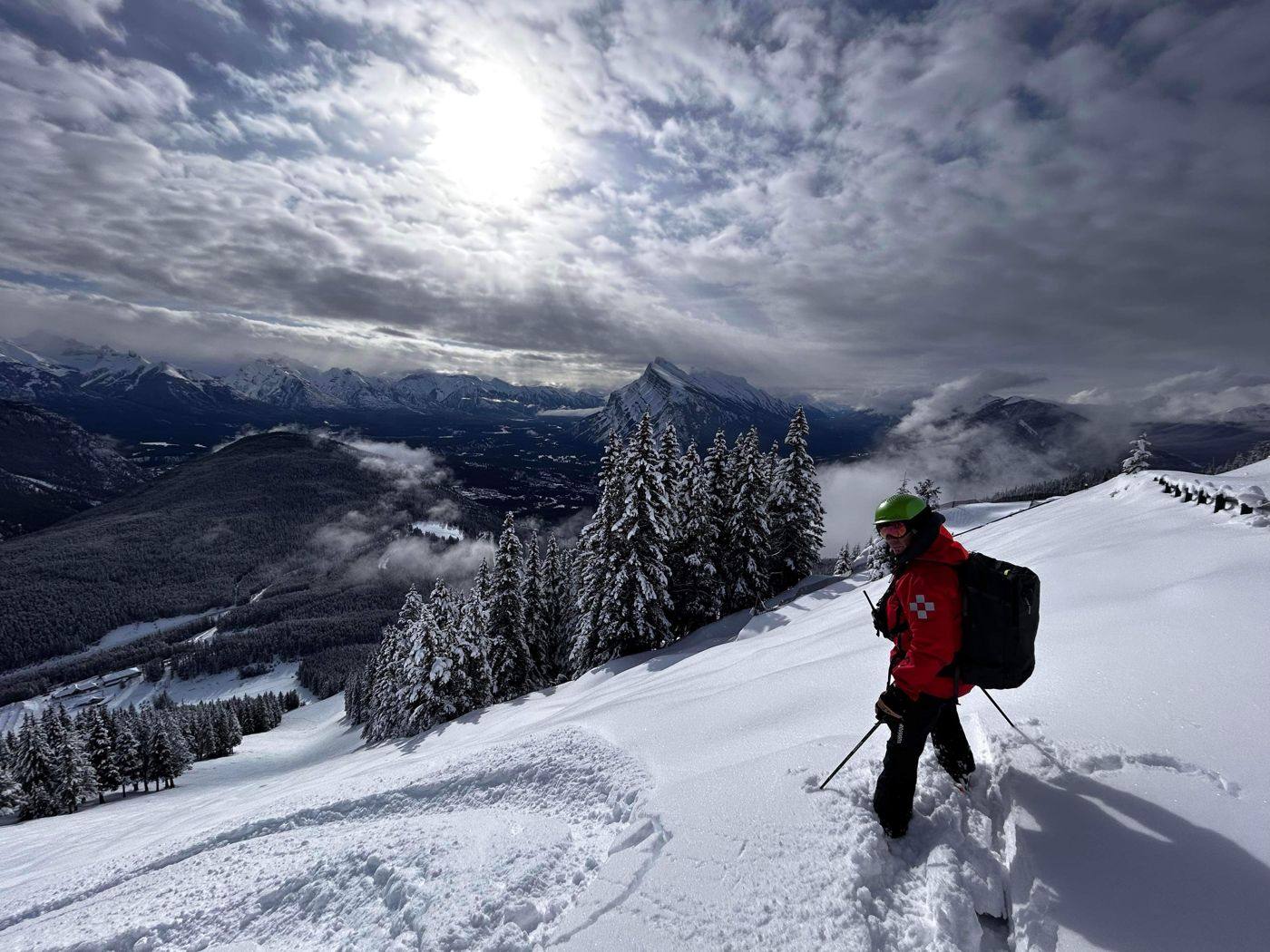 Ski patroller on a snowy ridge