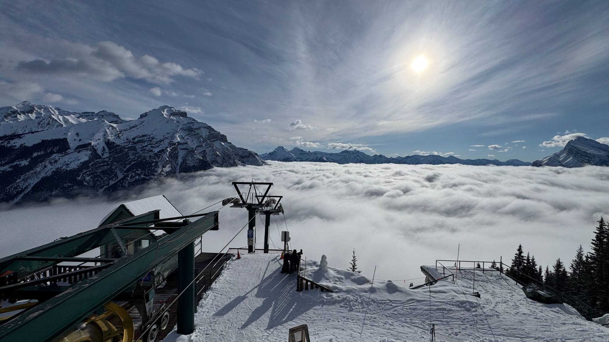 Chairlift summit above a sea of cloud